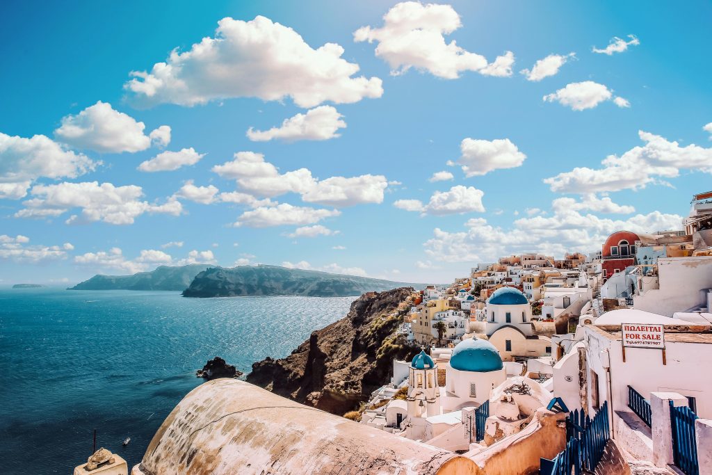 Captivating view of Santorini's famous blue-domed buildings under a vibrant sky.